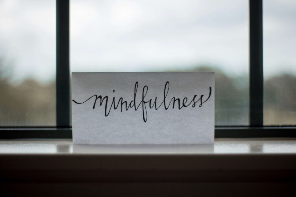 Mindfulness written on paper in the windowsill. With therapy for women in NYC, NY, you can learn to empower yourself! Get started with a therapist for women today.