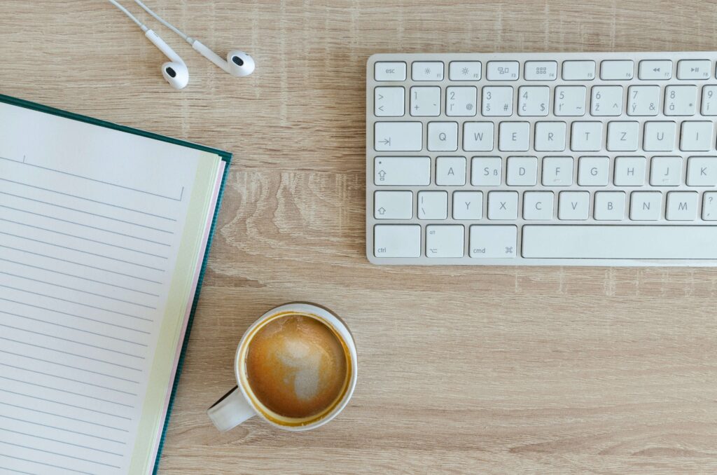 A white keyboard and coffee on desk. If you're looking for a therapist for women in NYC, NY then look no further! I offer women's therapy to help you.