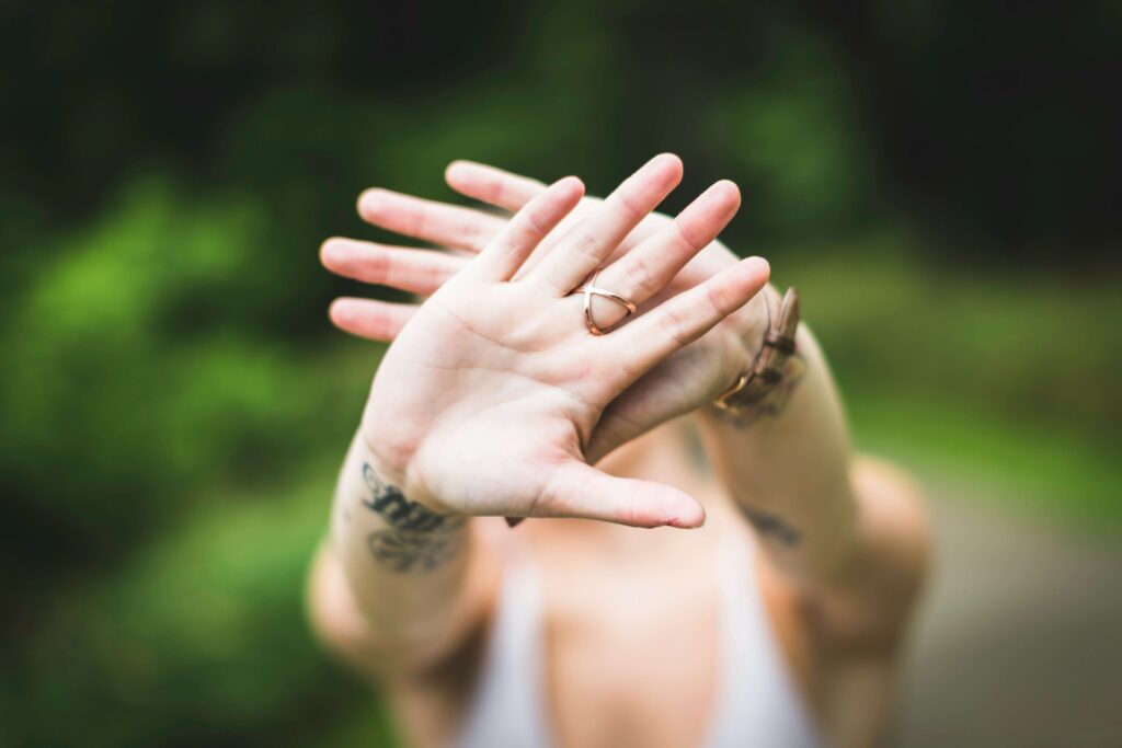 An individual putting their hands out. Representing how asserting boundaries can be difficult. Get the support you deserve with a women's therapist in NYC. 