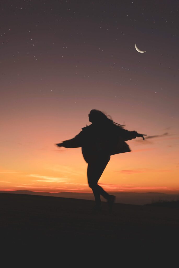 A woman dancing in the sunset. If you need help setting boundaries, get started with women issues therapy in NYC, NY today! As a women's therapist, I can help. 