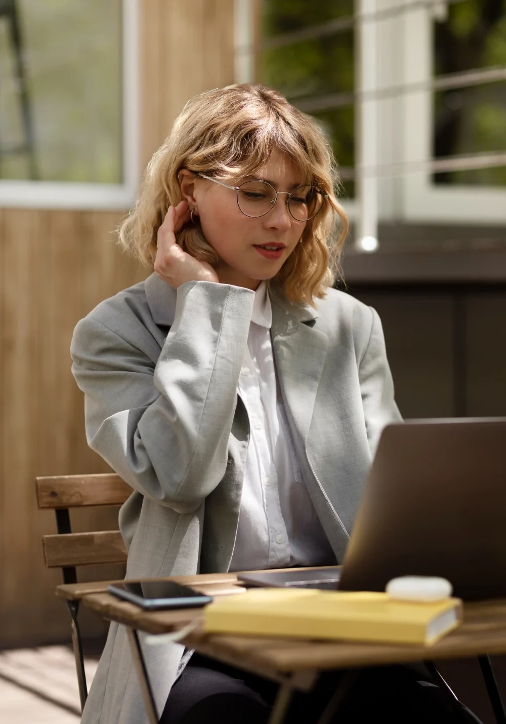 Thoughtful woman reflecting while working at her laptop